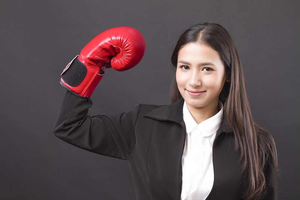 strong business woman punching, powerful impact on business competition concept